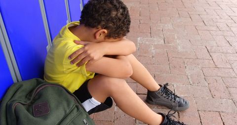 Upset Schoolboy Sitting Alone on Corridor Floor in Thought - Download Free Stock Images Pikwizard.com