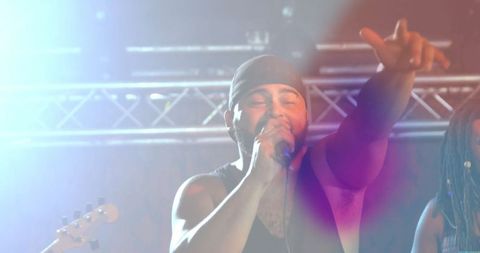 Energetic singer reaching out during live concert