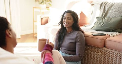 Diverse women sharing conversations in cozy living room ambiance