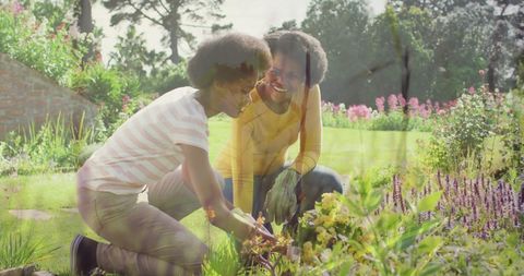 African Mother and Daughter Enjoying Gardening Together