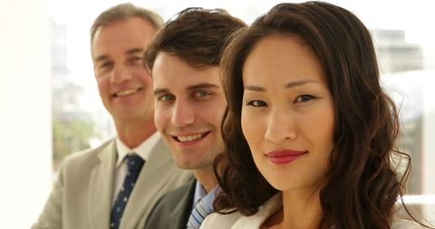 Confident Business Team Smiling in a Modern Office Environment