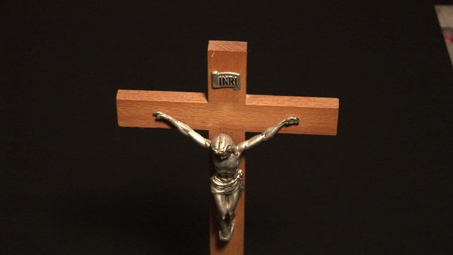 The wooden crucifix with a metal figure of Jesus serves as a powerful symbol of Christianity. The inclusion of 'INRI' at the top reaffirms its connection to the crucifixion. This videory is ideal for use in materials related to Christian teachings, religious education, church decor, or faith-themed publications. The dark background provides a stark contrast that accentuates the details of the crucifix, making it a striking visual centerpiece.