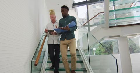 Diverse Businessmen Collaborating in Modern Office Staircase