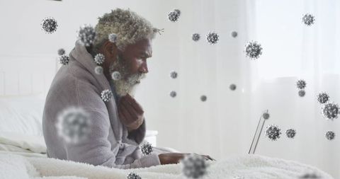 Man with Virus Figures Using Laptop During Pandemic