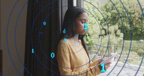 Young woman holding smartphone viewing futuristic radar binary interface overlay on balcony