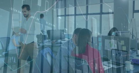 Financial analysts reviewing data with graph overlays in modern office