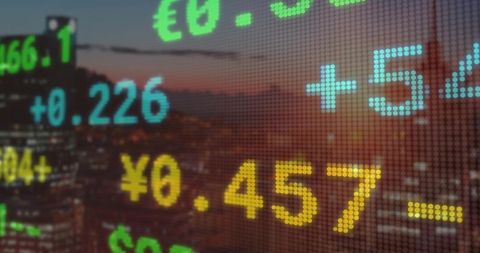Digital Currency Display Over Cityscape at Dusk with LED Style