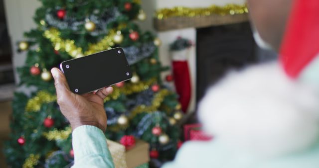 Person Holding Smartphone During Christmas Celebration - Download Free Stock Images Pikwizard.com