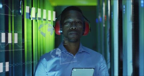 Focused IT Technician Analyzing Data in Server Room