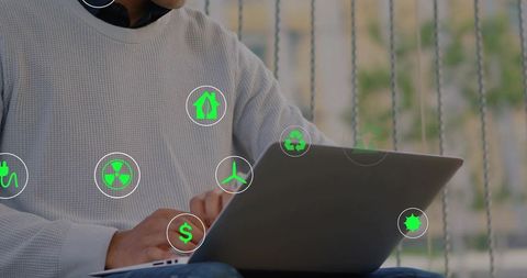 Man typing on laptop with green eco icons overlay for remote work sustainability fintech