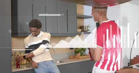 Young men leaning at modern kitchen counter laughing, sharing red bottle with data overlay