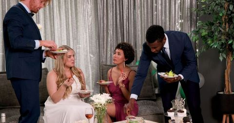 Multicultural wedding reception inside cozy living room