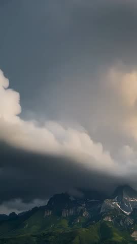 Vertical Video Sunset Light Shifting Lenticular and Cumulus Clouds Over Mountain Peak