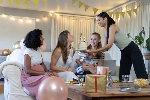 Diverse Group of Women Celebrating 30th Birthday with Baby in Cozy Living Room