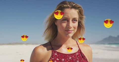 Smiling Woman on Beach with Floating Heart Emojis