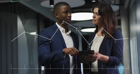 Diverse Business Team Analyzing Data in Office Corridor