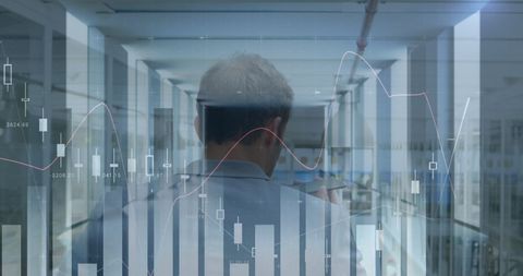 Businessman in Futuristic Office with Financial Graphs Display - Download Free Stock Images Pikwizard.com