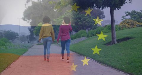 Friends strolling path in park with flag overlay