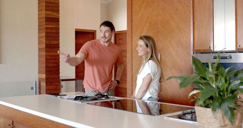 Friends chatting in modern kitchen relaxing atmosphere