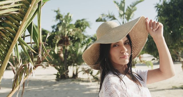 Woman in sun hat smiling on tropical beach on sunny day - Download Free Stock Images Pikwizard.com