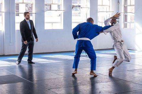 Martial artists sparring in mosaic of tradition and skill