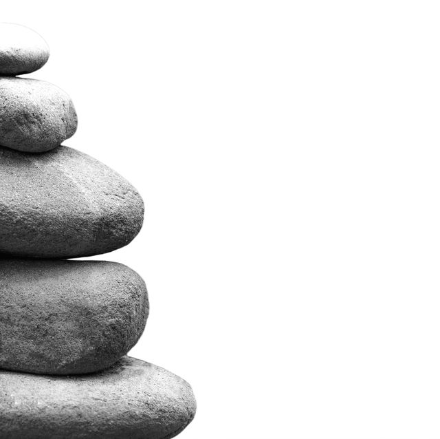 Balancing stones on white background representing balance, meditation, and simplicity. Suitable for wellness, mindfulness practice, minimalistic design projects, nature themes, or inspirational and motivational materials.