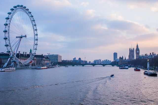 This image depicts the London Eye and River Thames at sunset, showcasing iconic landmarks against a beautifully colored sky. Great for travel blogs, tourism advertisements, cityscape collections, and illustrations of UK landmarks.