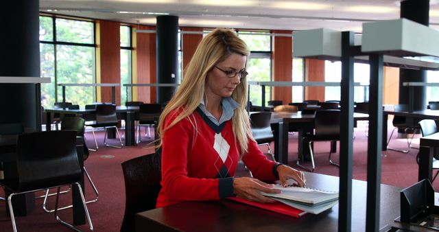 Thoughtful Woman Studying in Modern Library - Download Free Stock Images Pikwizard.com