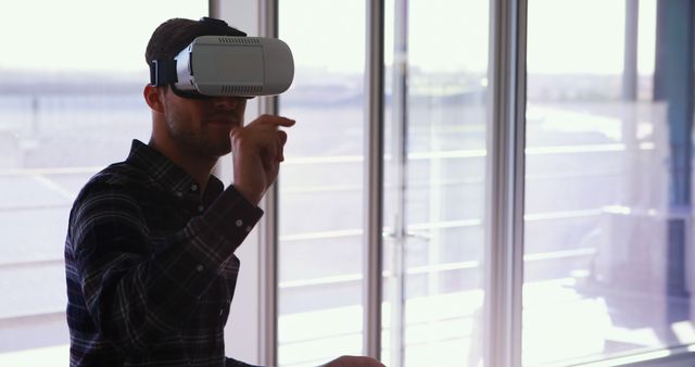 Man Experiencing Virtual Reality with VR Headset in Bright Room - Download Free Stock Images Pikwizard.com