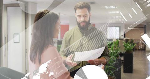 Business Professionals Discussing Documents with Data Visuals