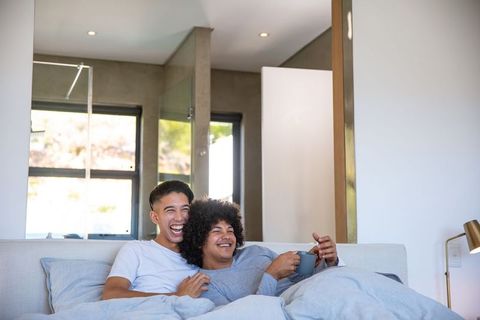 Cozy diverse couple relaxing with coffee at home