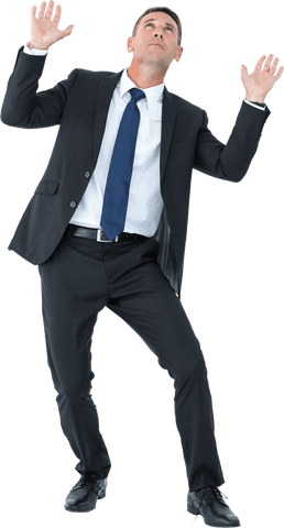 Focused businessman in suit while intently catching object transparent cutout