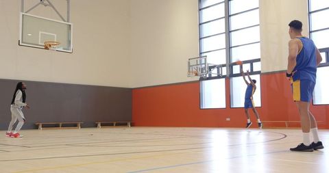 Diverse Basketball Team Practicing Shooting Skills Indoors