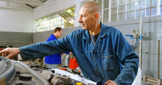 Male Mechanics Repairing Car in Workshop - Download Free Stock Images Pikwizard.com