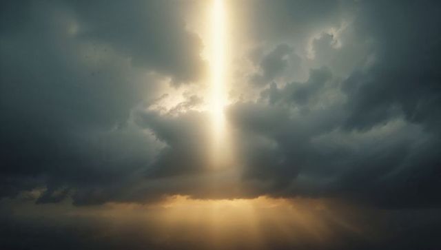 Golden light shaft over stormy seascape