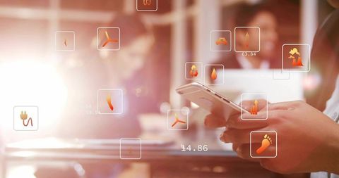 Asian businessman tapping smartphone with augmented reality HUD in coworking office