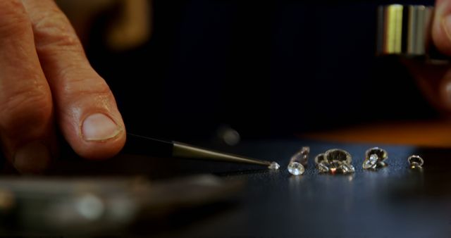 Jeweler's Hand Working with Diamonds and Gems on Black Surface - Download Free Stock Images Pikwizard.com