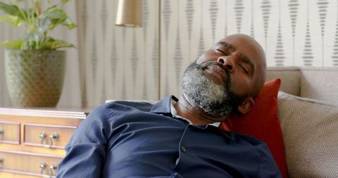 Man Sleeping Peacefully on Couch in Modern Living Room