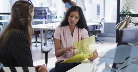 Diverse business professionals reviewing financial documents in modern office