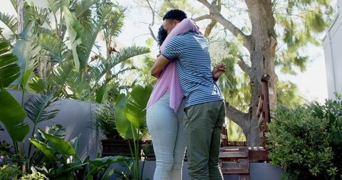 Romantic Engagement Proposal Outdoors Amidst Lush Greenery