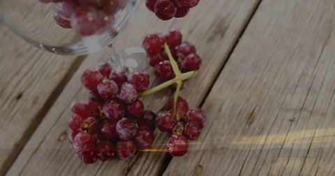 Frosted red grapes on rustic wooden table