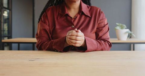 Businesswoman in Red Blouse Gesturing During Office Meeting