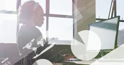Businesswoman Analyzing Data on Computer in Sunny Office