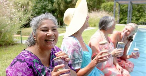 Joyful Senior Women Socializing by Outdoor Poolside