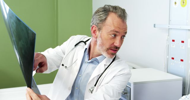 Experienced Doctor Examining X-Ray Image in Modern Clinic - Download Free Stock Images Pikwizard.com