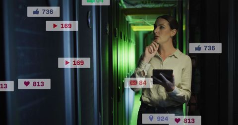 Female IT Technician Analyzing Data with Tablet in Server Room