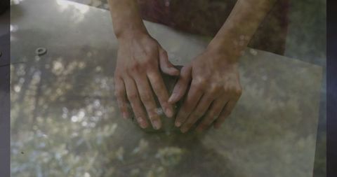 Artisan hands molding clay at pottery studio