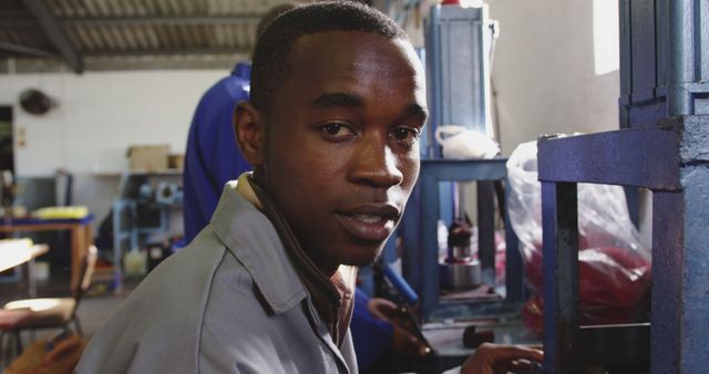 Young African Man Working in Industrial Workshop - Download Free Stock Images Pikwizard.com