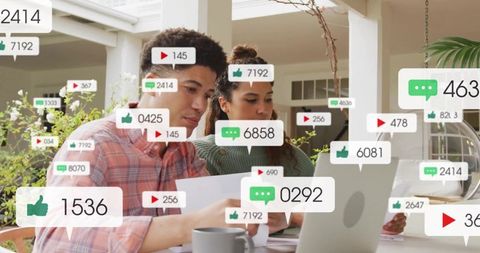 Couple analyzing social media engagement on laptop on sunlit porch with notifications
