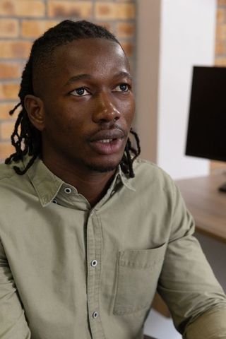 African american professional in contemporary office space listening attentively